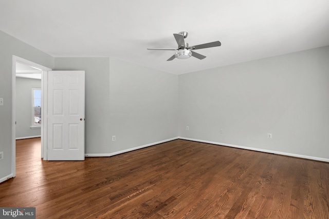 empty room featuring dark wood-type flooring and ceiling fan