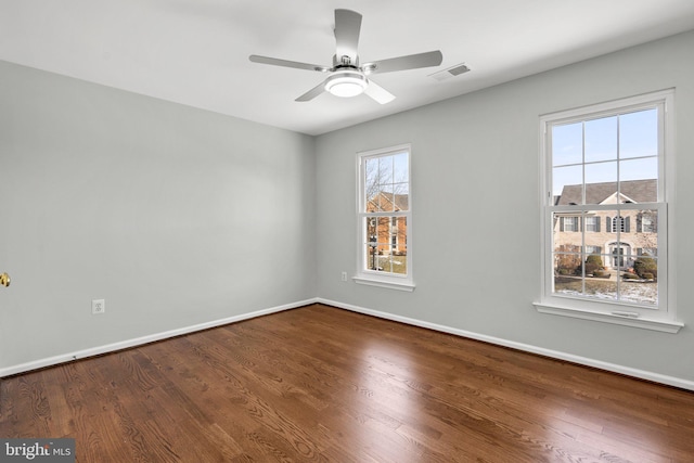 spare room featuring hardwood / wood-style floors, plenty of natural light, and ceiling fan