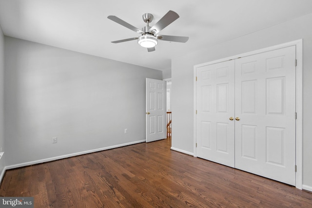 unfurnished bedroom featuring dark wood-type flooring, ceiling fan, and a closet