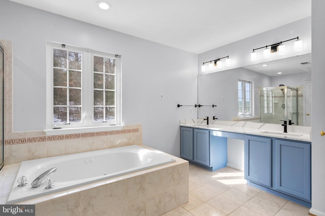 bathroom with independent shower and bath, vanity, plenty of natural light, and tile patterned flooring