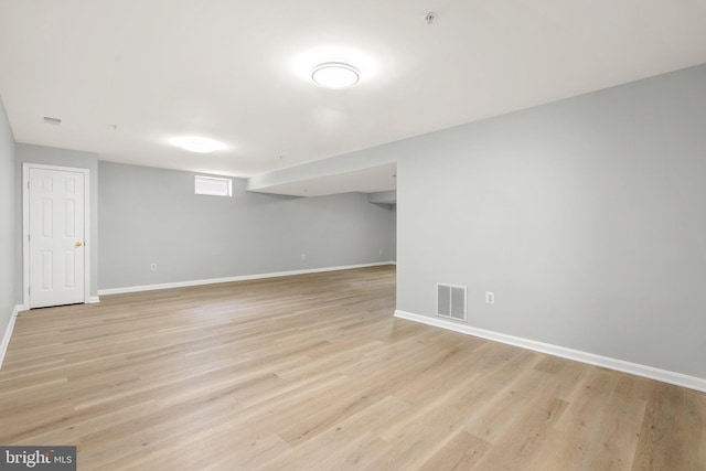 basement with light hardwood / wood-style flooring