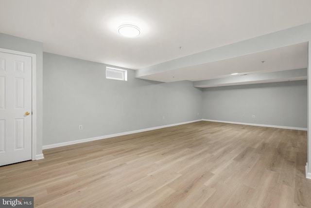 basement with light hardwood / wood-style flooring