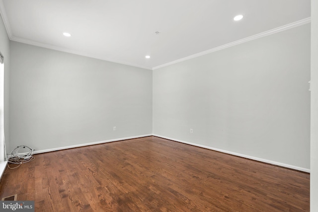 empty room with wood-type flooring and ornamental molding