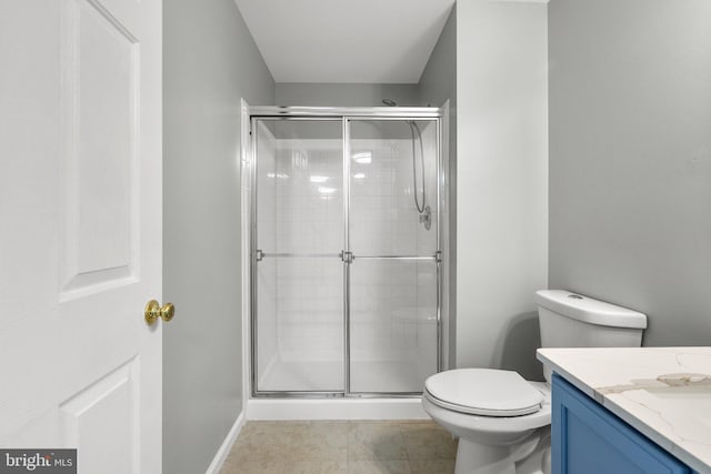 bathroom with vanity, toilet, and a shower with door