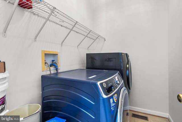 laundry room with washing machine and dryer