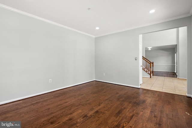 spare room with ornamental molding and light hardwood / wood-style flooring