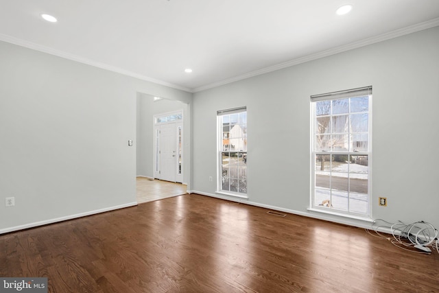 spare room with hardwood / wood-style flooring and crown molding
