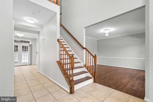 staircase featuring crown molding and tile patterned floors