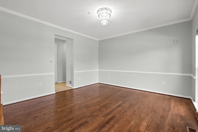 empty room featuring crown molding and light wood-type flooring