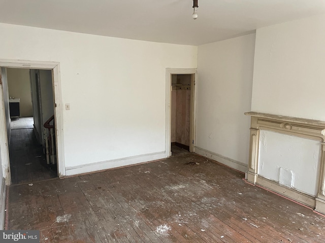 unfurnished living room featuring dark hardwood / wood-style floors