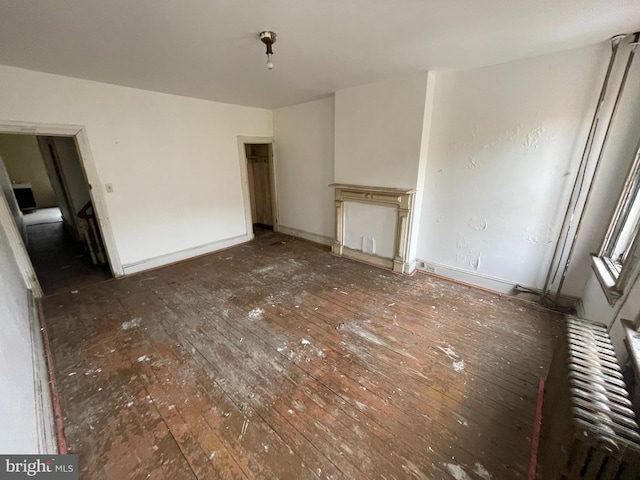 unfurnished living room featuring dark wood-type flooring