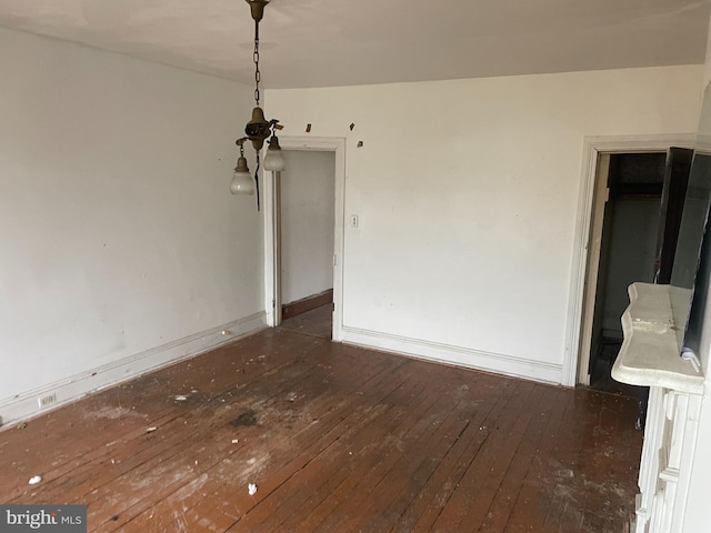 unfurnished dining area featuring dark hardwood / wood-style flooring