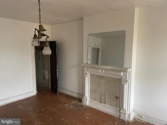 unfurnished dining area featuring dark wood-type flooring