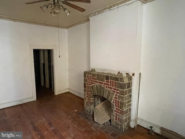 interior space with dark wood-type flooring, ceiling fan, and a fireplace