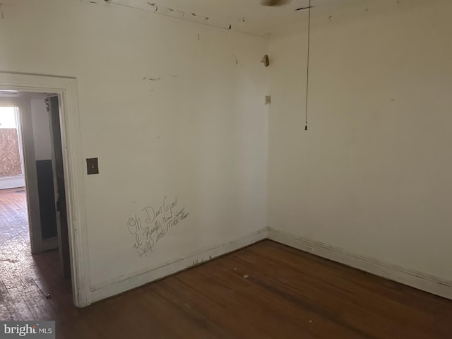 empty room featuring dark wood-type flooring