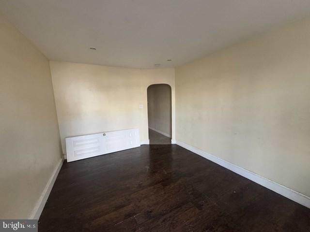 empty room featuring dark hardwood / wood-style flooring