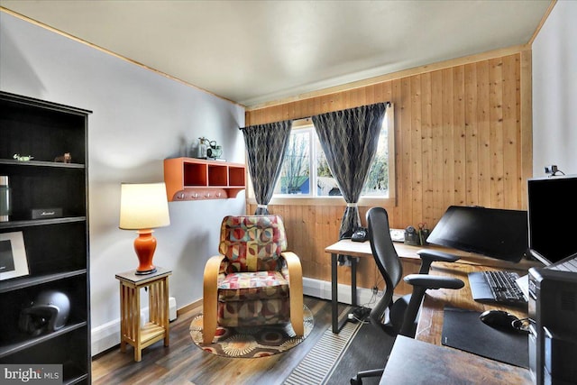 office area with dark wood-style flooring and wooden walls