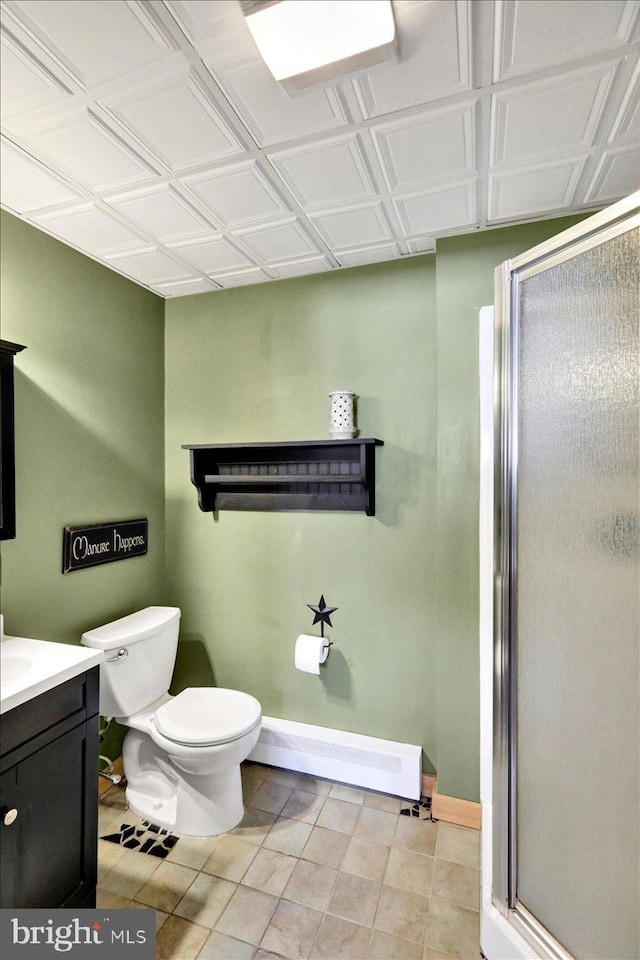 full bath with toilet, vanity, baseboards, baseboard heating, and an ornate ceiling