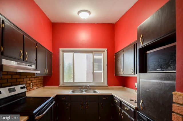 kitchen with stainless steel range with electric stovetop, decorative backsplash, and sink