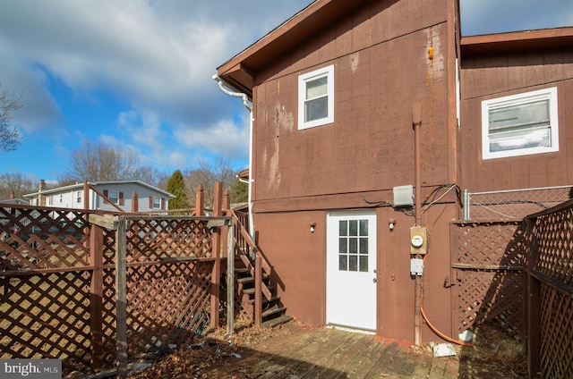 view of property exterior with a wooden deck