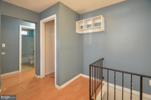 hallway with hardwood / wood-style floors