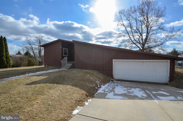 view of front of property with a front lawn, a garage, and an outbuilding