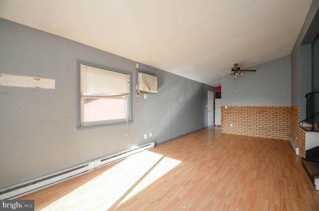 unfurnished living room with wood-type flooring, a baseboard heating unit, ceiling fan, and vaulted ceiling