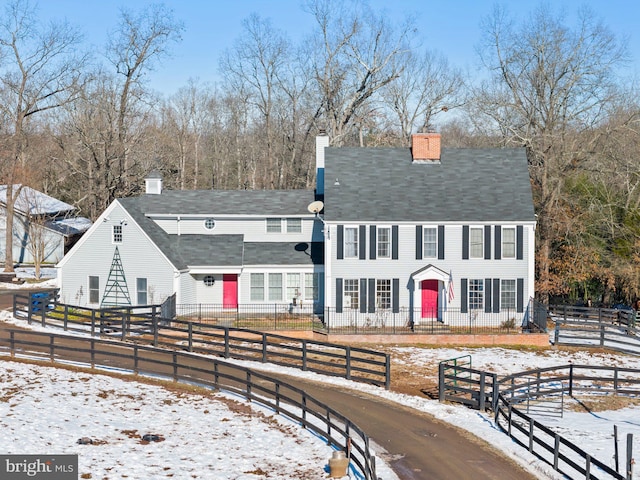 view of snow covered back of property