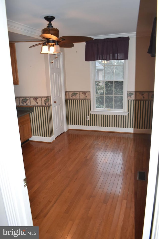 unfurnished room featuring crown molding, ceiling fan, and wood-type flooring