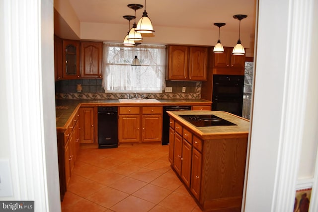 kitchen with sink, decorative light fixtures, black appliances, and decorative backsplash