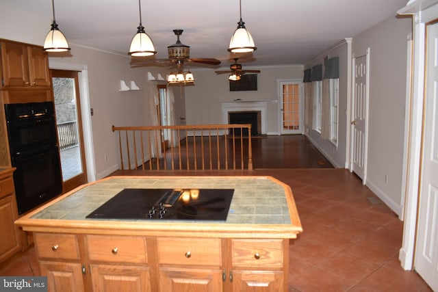 kitchen featuring ceiling fan, tile patterned flooring, a kitchen island, and black appliances