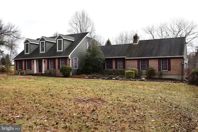 cape cod home with a front lawn