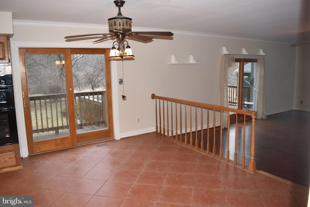 interior space featuring tile patterned flooring, crown molding, and ceiling fan