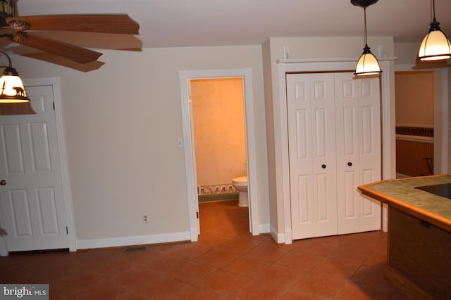 interior space with tile patterned floors and decorative light fixtures