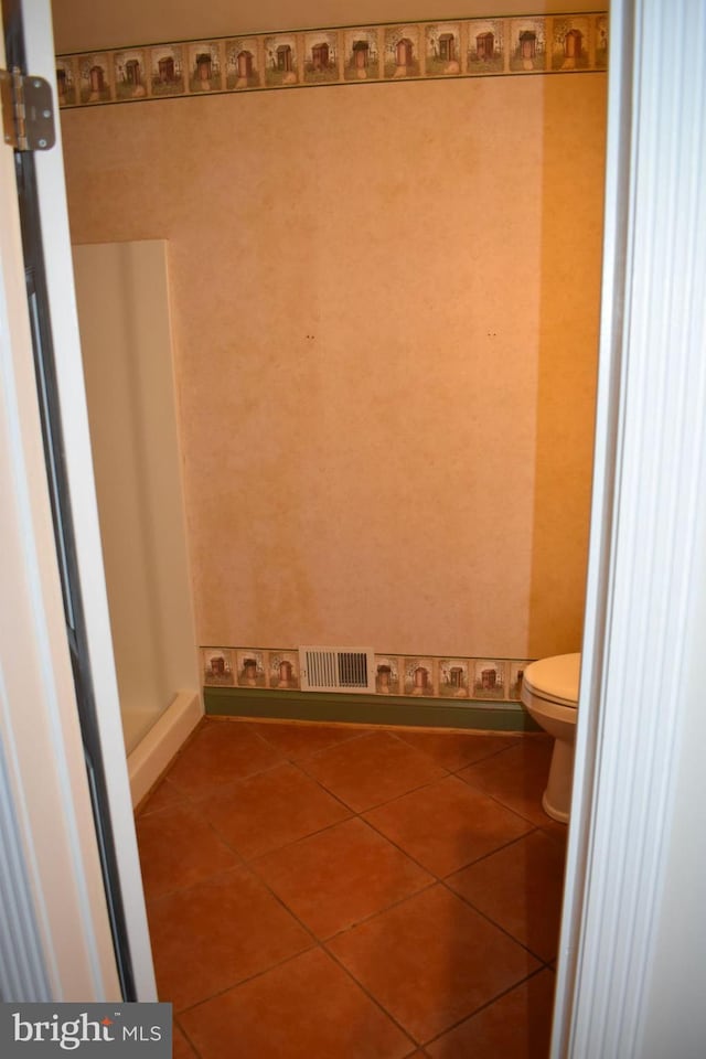 bathroom with tile patterned floors and toilet