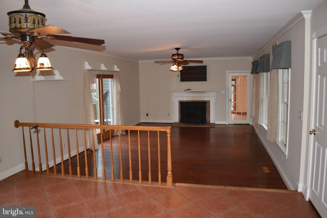 corridor with tile patterned flooring and crown molding