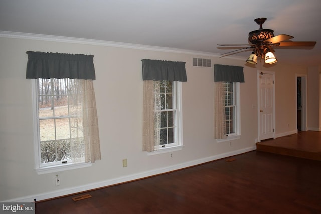 empty room with ceiling fan, ornamental molding, hardwood / wood-style floors, and plenty of natural light