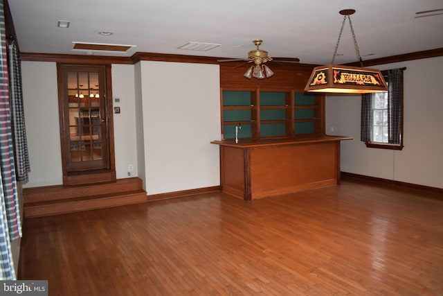 interior space featuring hardwood / wood-style flooring, ornamental molding, and ceiling fan