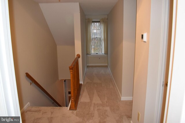 corridor featuring light colored carpet