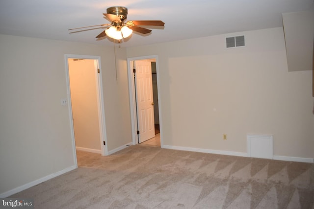 spare room with light colored carpet and ceiling fan