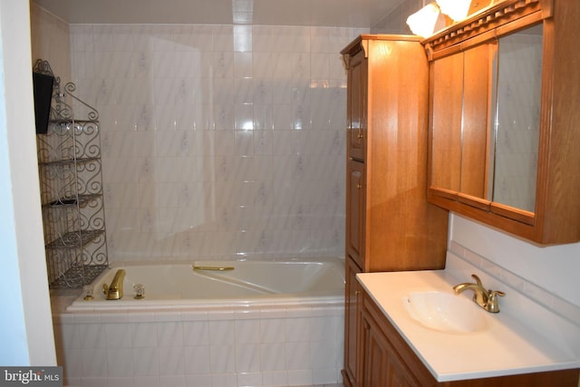 bathroom featuring vanity and tiled bath