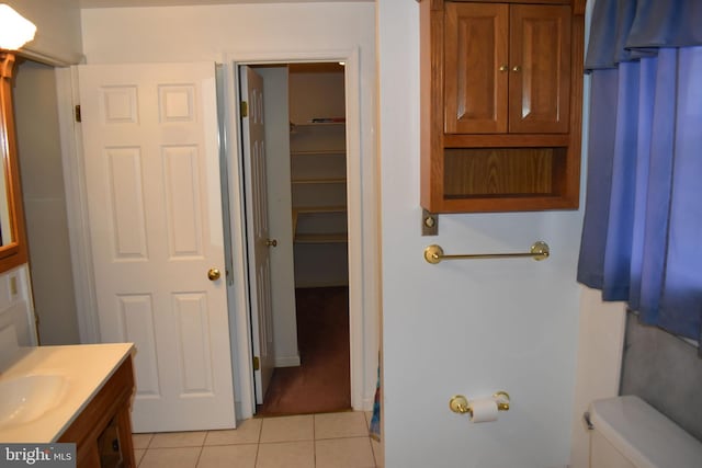 bathroom featuring vanity, tile patterned floors, and toilet