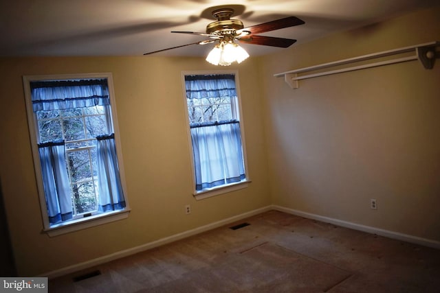 spare room featuring carpet floors and ceiling fan