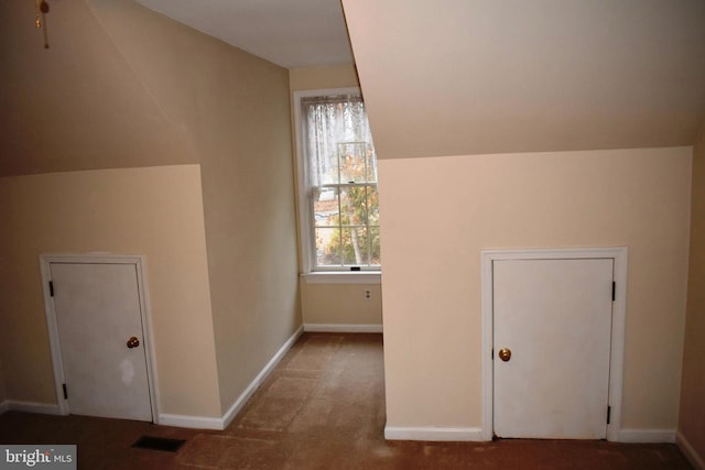 bonus room featuring lofted ceiling and carpet floors