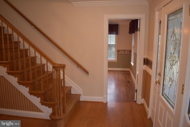 foyer featuring hardwood / wood-style flooring and ornamental molding