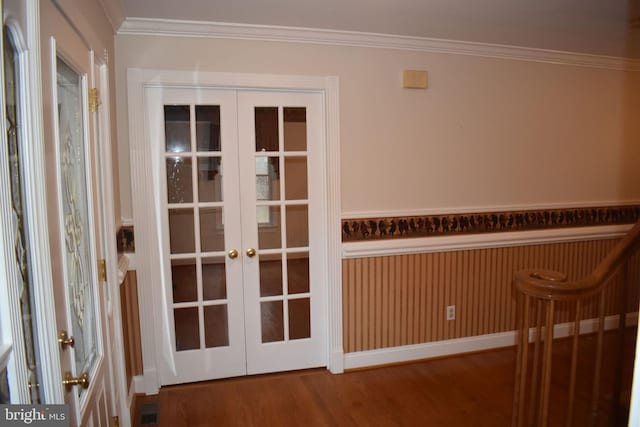 interior space with french doors, crown molding, and hardwood / wood-style flooring