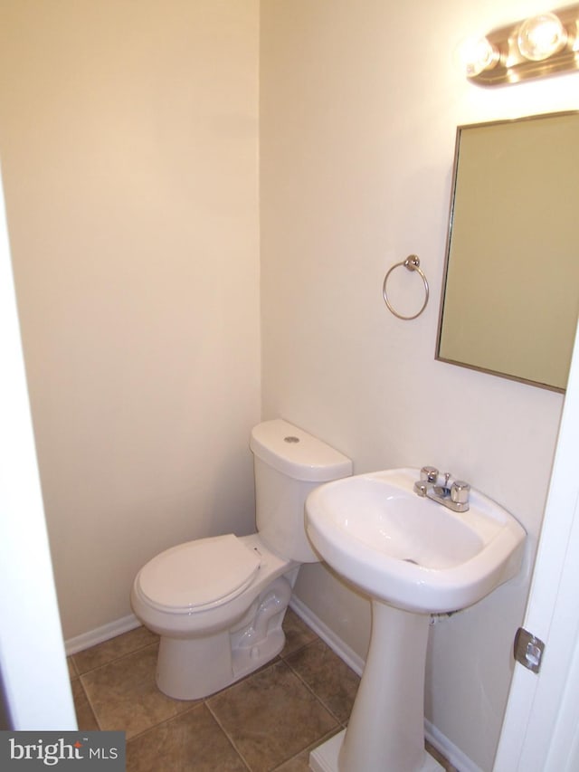 bathroom featuring toilet and tile patterned flooring