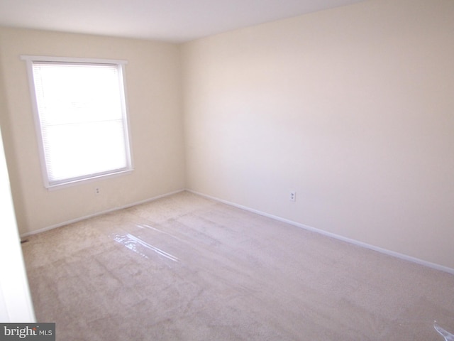 unfurnished room with light colored carpet