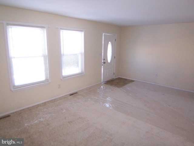 entryway with light colored carpet