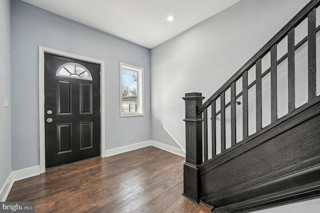 entryway with dark hardwood / wood-style flooring